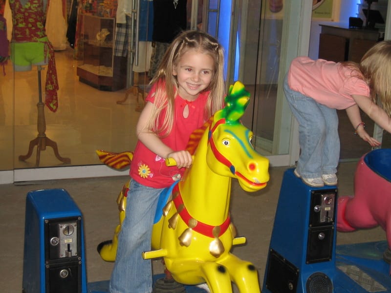 Emily riding a toy horse