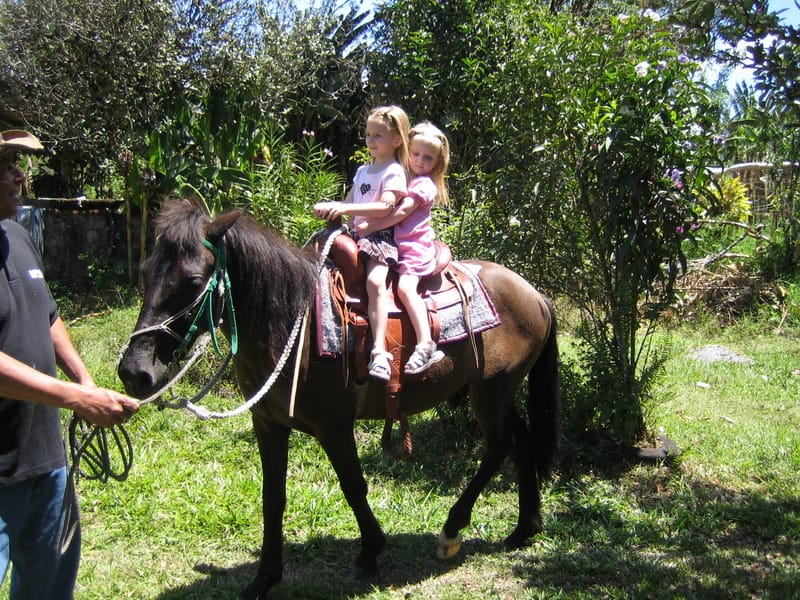 Emily and Marie riding a horse