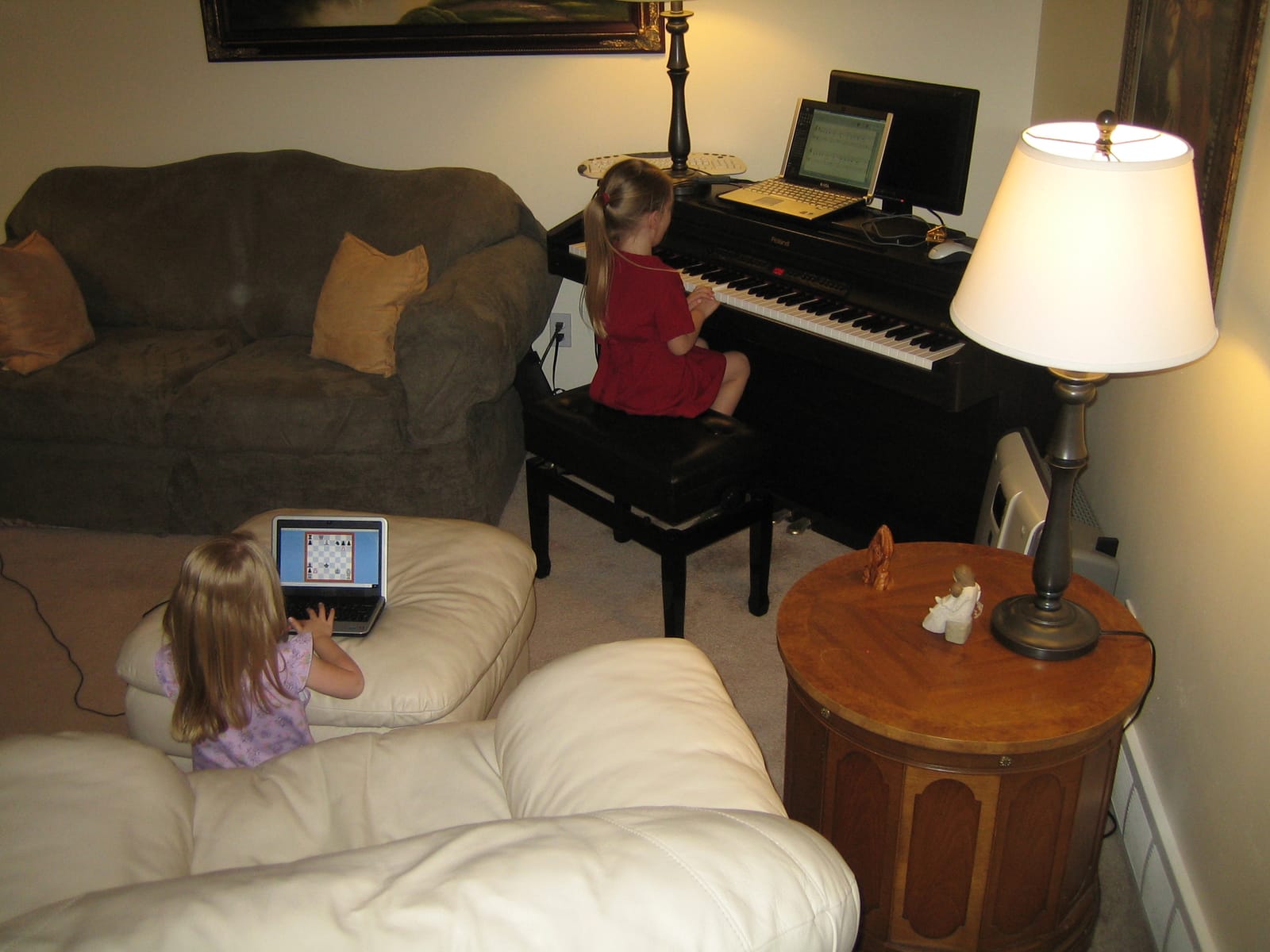 Marie playing chess, and Emily on the piano