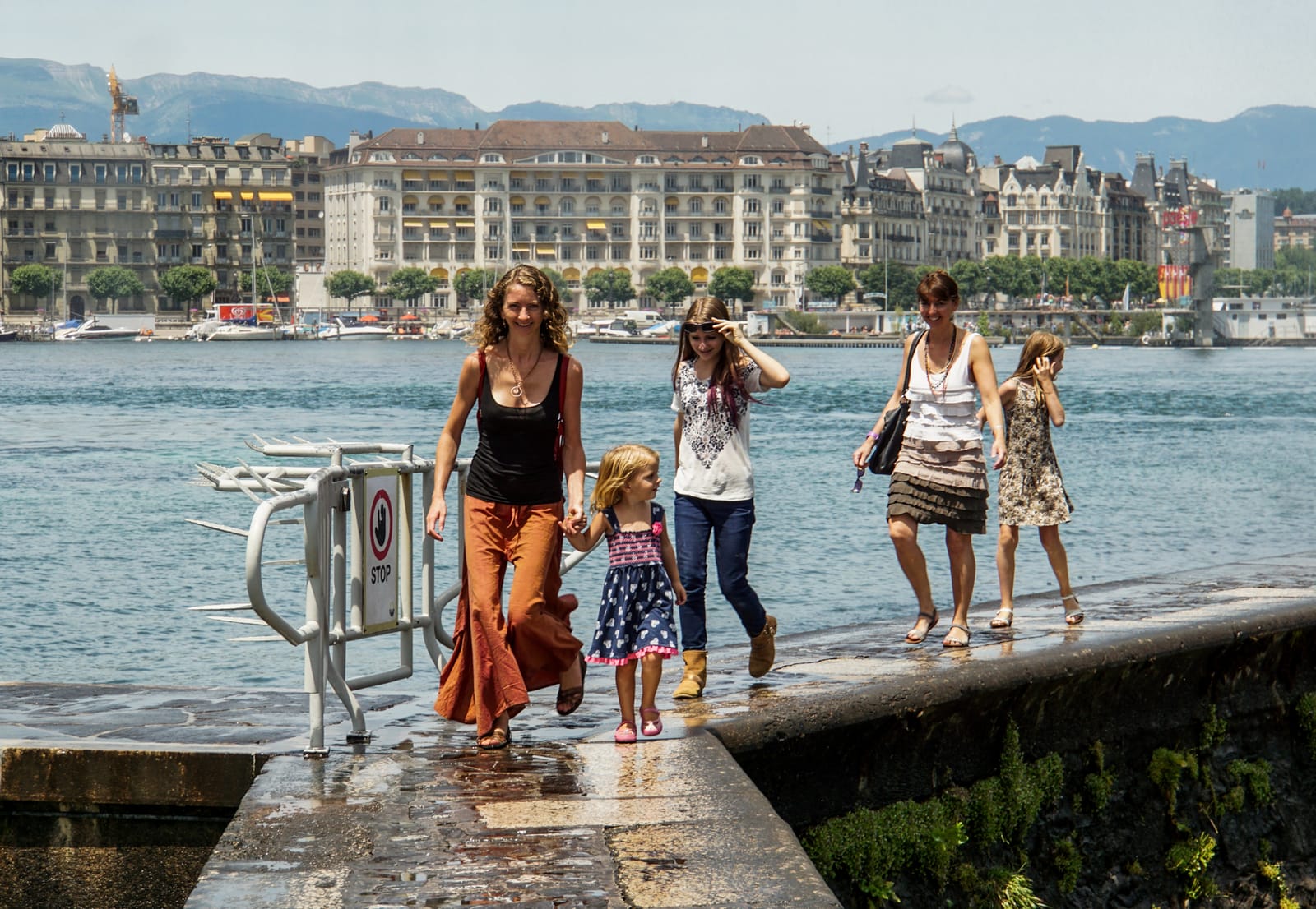 Running from falling water at Jet D'Eau in Geneva, Switzerland