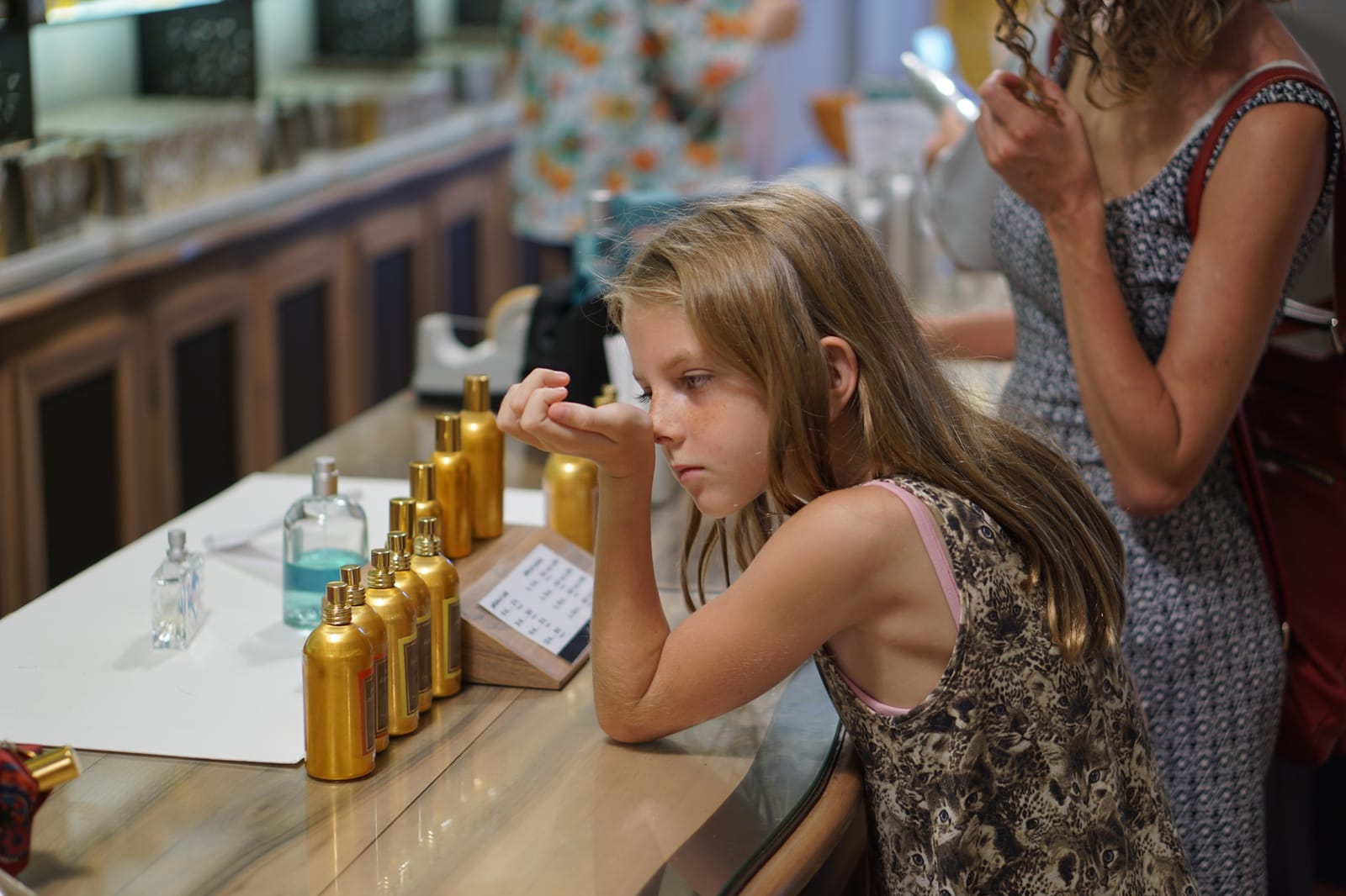 Smelling perfume.