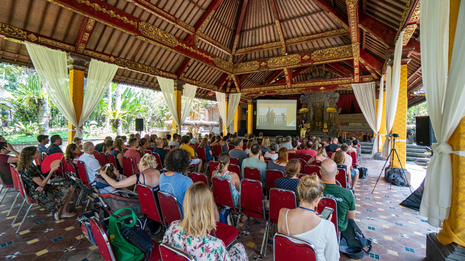 A hall full of attendees seated for one of the keynote sessions