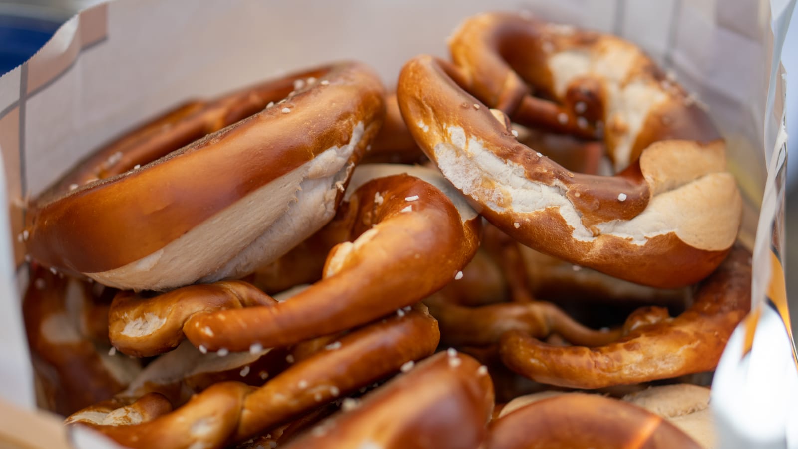 A bakery bag full of big, soft German pretzels